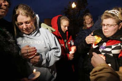 
Sue Abrams, of Rhinelander, left, comforts Kathrin See, 18, of Crandon, during a candlelight vigil Tuesday in Rhinelander, Wis. Victim Jordanne Murray was See's cousin. Associated Press
 (Associated Press / The Spokesman-Review)