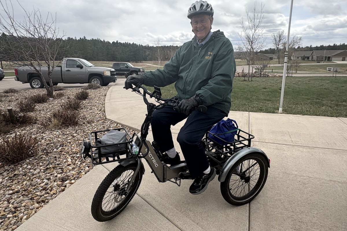 Ed McLaughlin, 96, on his e-tricycle, which he rides every day for about seven miles.