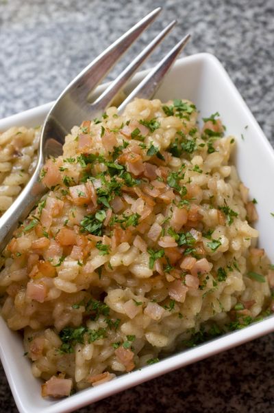 Partially cooking brown rice before using it in a traditional risotto recipe yields tasty results. Brown rice retains a firmer texture longer and actually is more forgiving when making risotto. (Associated Press)