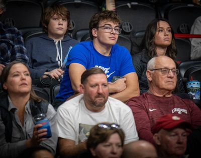 Former Eastern Washington guard Casey Jones, top center, watches the game between the Eagles and Washington State, the team he will join after a two-year mission, at the Arena on Thursday.  (Colin Mulvany/The Spokesman-Review)