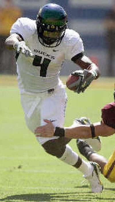 
Oregon wide receiver Jaison Williams eludes a tackle. 
 (Associated Press / The Spokesman-Review)