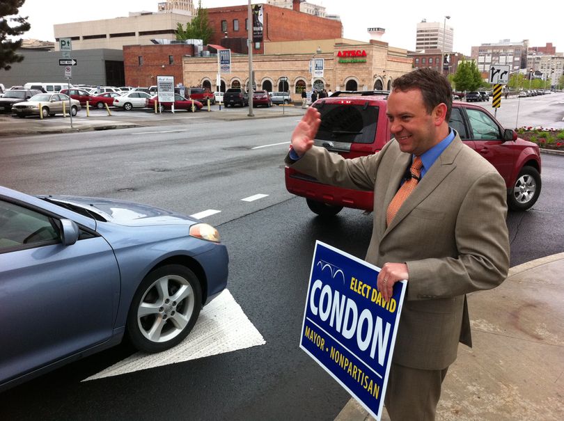 David Condon waves to cars headed into the downtown Doubletree Hotel, where he later addressed attendees at his kick-off breakfast May 24 for his campaign for Spokane mayor. (Jonathan Brunt)
