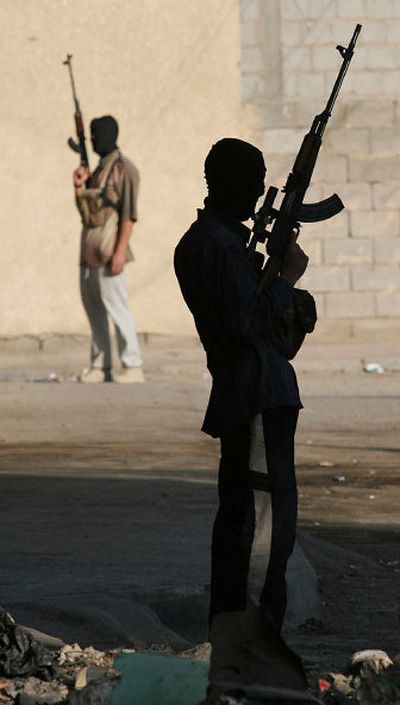 
Suspected insurgents hold weapons Monday in the streets of Ramadi, Iraq, after reported clashes between gunmen and Iraqi security forces in the early morning.
 (Associated Press / The Spokesman-Review)