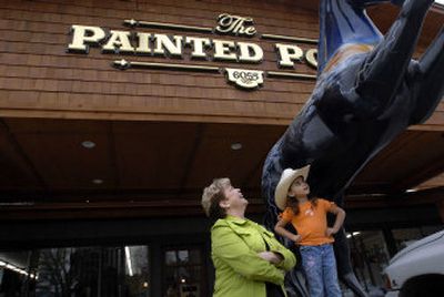 
Genny Scheel, owner of the Painted Pony in Coeur d'Alene, talks with 3-year-old Austin Lynn Samora outside the newly remodeled store at 6055 Government Way on Wednesday. 
 (Jesse Tinsley / The Spokesman-Review)