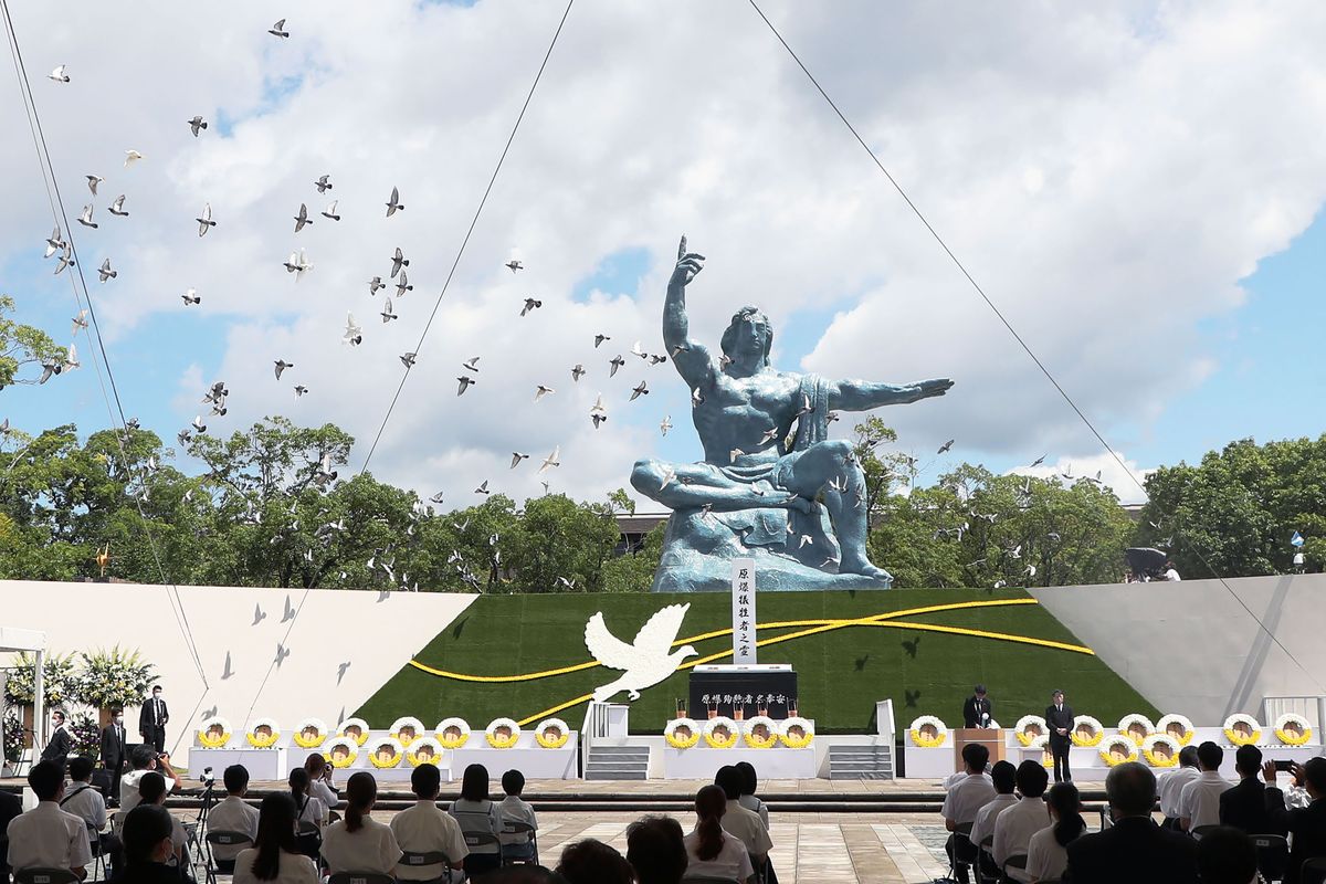 Doves fly over the Statue of Peace during a ceremony at Nagasaki Peace Park in Nagasaki, southern Japan Monday, Aug. 9, 2021. The Japanese city of Nagasaki on Monday marked its 76th anniversary of the U.S. atomic bombing.  (SUB)
