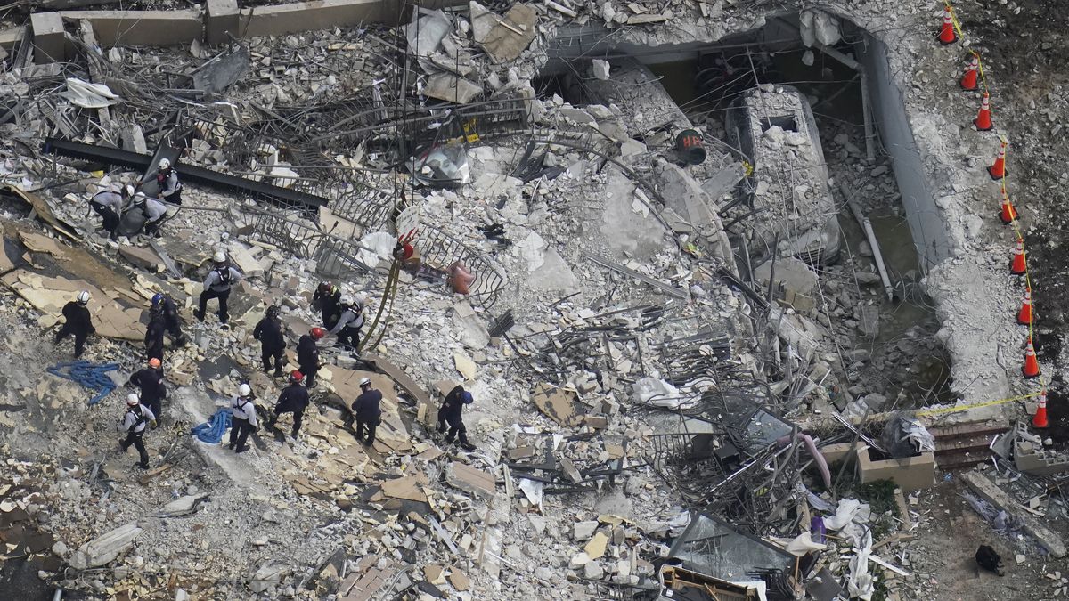 FILE - In this Saturday, June 26, 2021, file photo, rescue workers search in the rubble at the Champlain Towers South Condo, in Surfside, Fla. Even as the search continues over a week later for signs of life in the mangled debris of the fallen Champlain Towers South, the process of seeking answers about why it happened and who is to blame is already underway in Florida's legal system.  (Gerald Herbert)