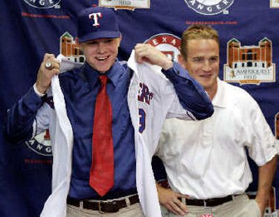 
Texas Rangers scout Jeff Wood, right, stands by top draft pick Kasey Kiker during a news conference Wednesday. 
 (Associated Press / The Spokesman-Review)