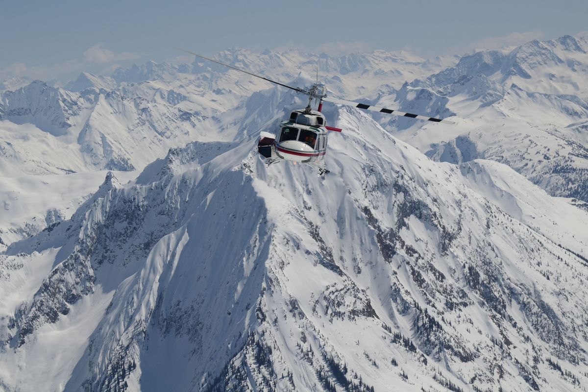 A Bell helicopter transports Canadian Mountain Holidays skier to fresh mountain powder in British Columbia. (Brad  White / CMH Heli-Skiing)