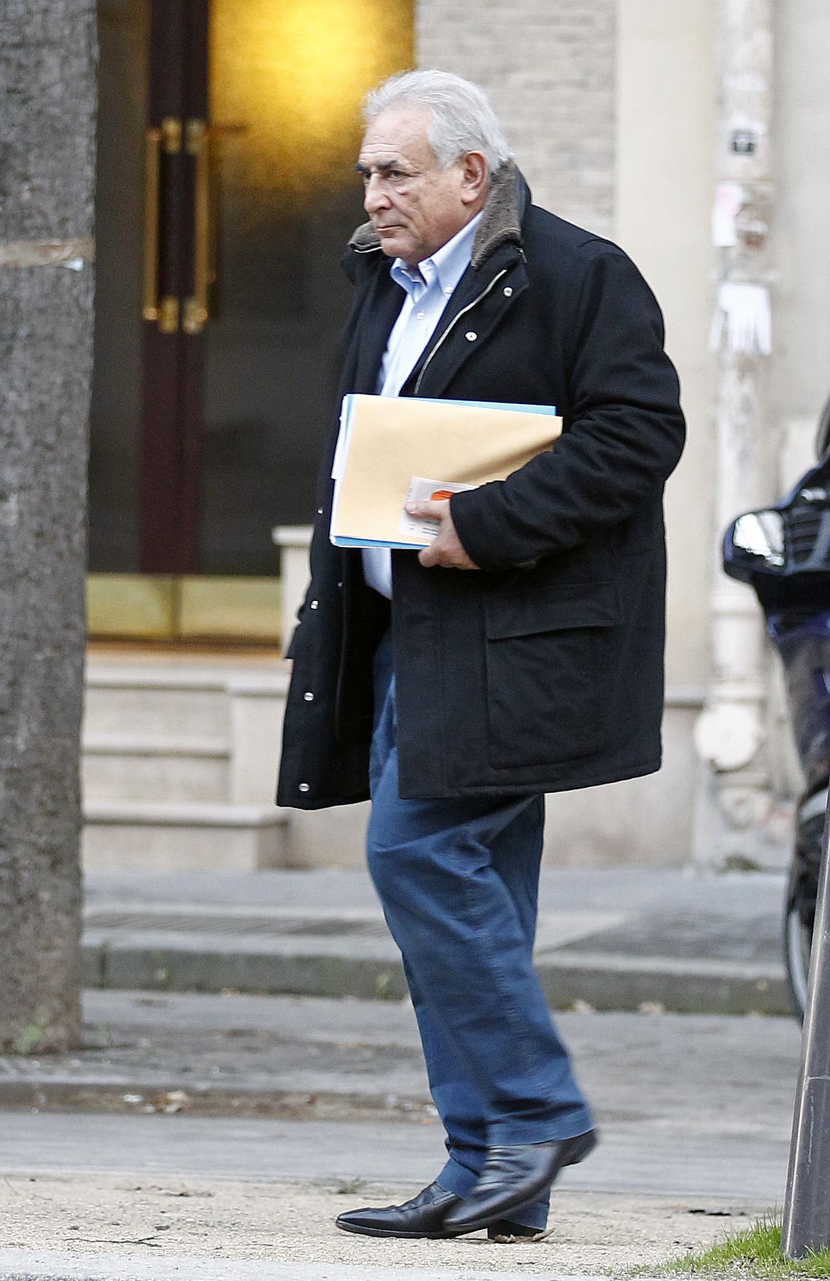 Former International Monetary Fund leader Dominique Strauss-Kahn leaves his apartment building in Paris, Monday Dec. 10, 2012. The outcome of a New York City hotel housekeeper