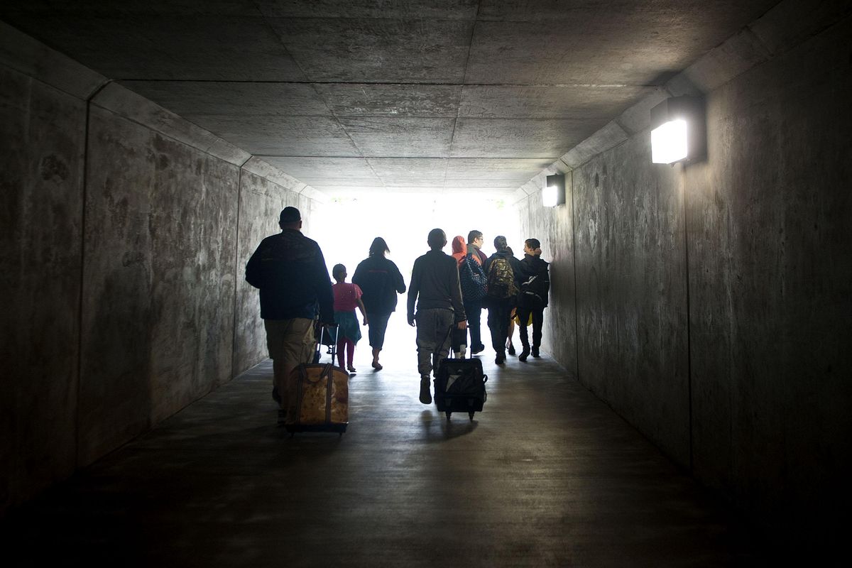 The crowd makes walks through the tunnel on their way to Silverwood Theme Park in Athol on Thursday, June 15, 2017. (Kathy Plonka / The Spokesman-Review)