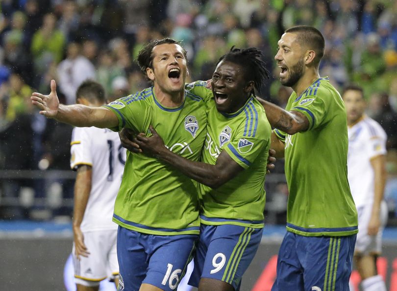 Seattle Sounders' Nelson Valdez, left, celebrates with teammates Obafemi Martins, center, and Clint Dempsey, right, after Valdez scored a goal against the Los Angeles Galaxy in the first half of an MLS soccer western conference knockout round playoff match, Wednesday, Oct. 28, 2015, in Seattle. (AP Photo/Ted S. Warren) ORG XMIT: WATW106 (Ted S. Warren / AP)