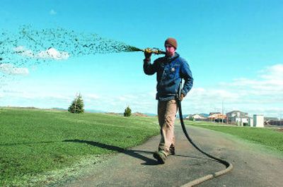 
Caleb Gutting of Riverview Landscaping sprays hydroseed along new bike paths in the area of the Fieldstone subdivision. 
 (Jesse Tinsley / The Spokesman-Review)