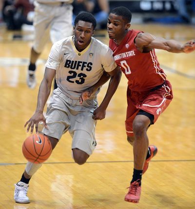 Colorado’s Jaron Hopkins dribbles past Washington State’s Ike Iroegbu during second-half action on Saturday in Boulder, Colorado. (Associated Press)