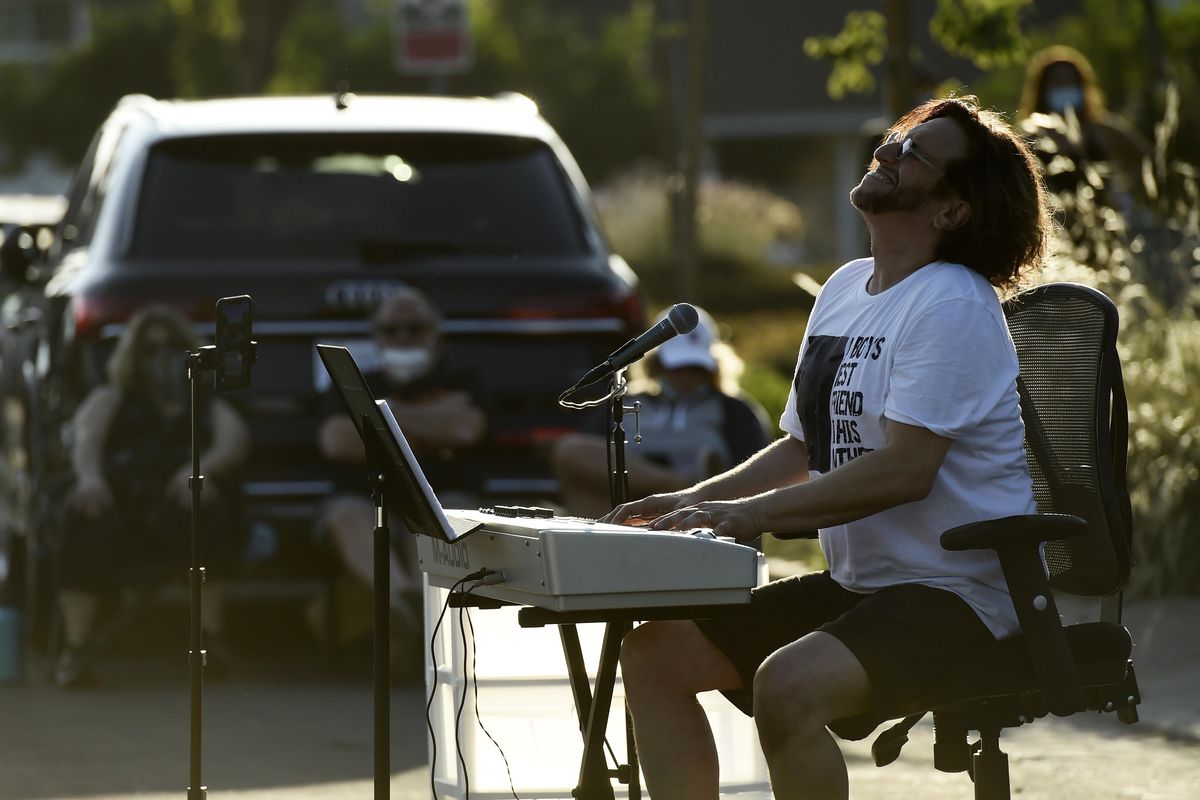 Musician Adam Chester performs his weekly neighborhood concert. (Chris Pizzello / Chris Pizzello/Invision/AP)