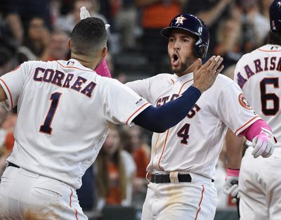 CORRECTS TO BRETT MARTIN-Houston Astros' George Springer (4) celebrates his two-run home run off Texas Rangers relief pitcher Brett Martin with Carlos Correa during the sixth inning of a baseball game against the Texas Rangers, Sunday, May 12, 2019, in Houston. (Eric Christian Smith / Associated Press)