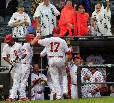Chicago’s Tyler Flowers (17) is greeted at dugout after hitting a two-run home run that proved to be difference. (Associated Press)