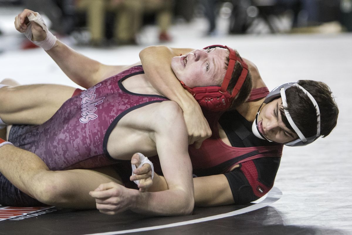 Two-time state champion Trevor Morrison, right, of Colville, on his way to a pin win over Newport’s Keelen Mitcham in the 1A first round of Mat Classic XXXI in Tacoma on Friday. (Patrick Hagerty / Patrick Hagerty)