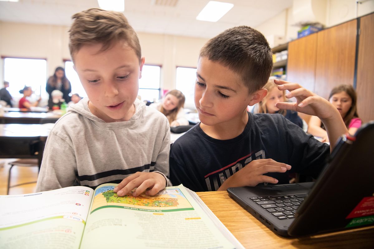 Adams Elementary fourth-graders Sam Mazhan, left, and Danylo Vulpe work on a social studies project together Thursday. Their teacher, Olivia Hamilton, talked about how to keep kids engaged and learning through the summer. (Jesse Tinsley / The Spokesman-Review)
