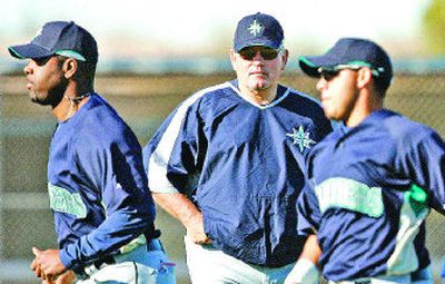 
M's manager Mike Hargrove, center, watches Arthur Rhodes, left, and Rene Rivera jog on first day of spring training Thursday. 
 (Associated Press / The Spokesman-Review)