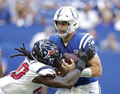 Indianapolis Colts quarterback Andrew Luck  is sacked by Houston’s Jadeveon Clowney  during the first half  on Sept. 20 in Indianapolis. (Michael Conroy / AP)