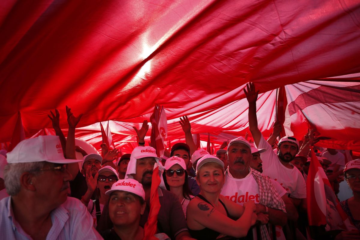 Supporters of Kemal Kilicdaroglu, the leader of Turkey’s main opposition Republican People’s Party, hold a huge Turkish flag as they gather for a rally following their 265-mile “March for Justice” in Istanbul, Sunday, July 9, 2017. Kilicdaroglu, along with thousands of supporters walked from the capital Ankara to an Istanbul prison, began to denounce the imprisonment of a party lawmaker but has grown into a wider protest of Turkey’s President Recep Tayyip Erdogan’s policies and the large-scale government crackdown on opponents in the wake of July 2016’s failed coup attempt. (Lefteris Pitarakis / Associated Press)