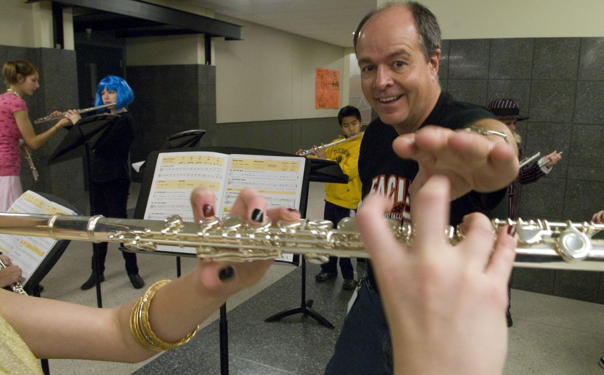 At West Valley High School,  Kyle Bosch, band director at Centennial Middle School, helps Seth Woodard Elementary fifth-grader, Bailey Nelson with her flute work. West Valley has started a program that brings fifth-grade beginning band students to the high school for practice a couple of mornings each week. The number of fifth-graders in band has sky rocketed, and there’s a waiting list of several dozen.  (Colin Mulvany / The Spokesman-Review)