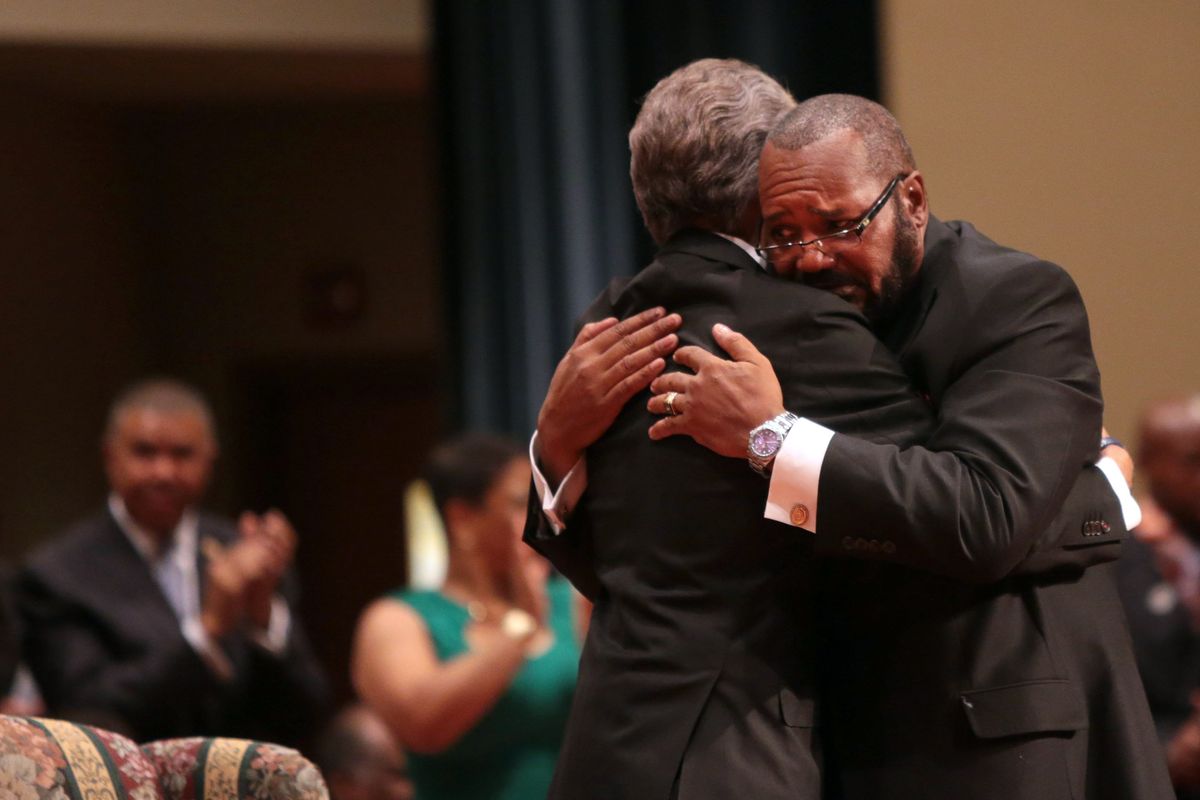 Pastor Charles Ewing, right, uncle of Michael Brown Jr., embraces Rev. Al Sharpton during the funeral services for Brown on Monday, Aug. 25, 2014, at Friendly Temple Missionary Baptist Church in St. Louis. Hundreds of people gathered to say goodbye to Michael Brown, the 18-year-old shot and killed Aug. 9 in a confrontation with a police officer that fueled almost two weeks of street protests. (Robert Cohen / St. Louis Post-dispatch Pool)