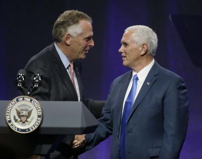Virginia Democratic Gov. Terry McAuliffe, left, shakes hands with Vice President Mike Pence before he addresses a NGA session titled “Collaborating to Create Tomorrow’s Global Economy” at the second day of the National Governors Association meeting Friday, July 14, 2017, in Providence, R.I. (Stephan Savoia / Associated Press)