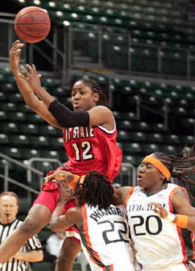 
N.C. State's Marquetta Dickens (12) gets airborne and is fouled by Fallon Phanord (22) of Miami. 
 (Associated Press / The Spokesman-Review)