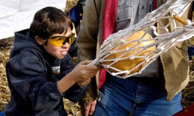 
Devin Selby, 12, of Herrick, Ill., aims his slingshot machine called the 