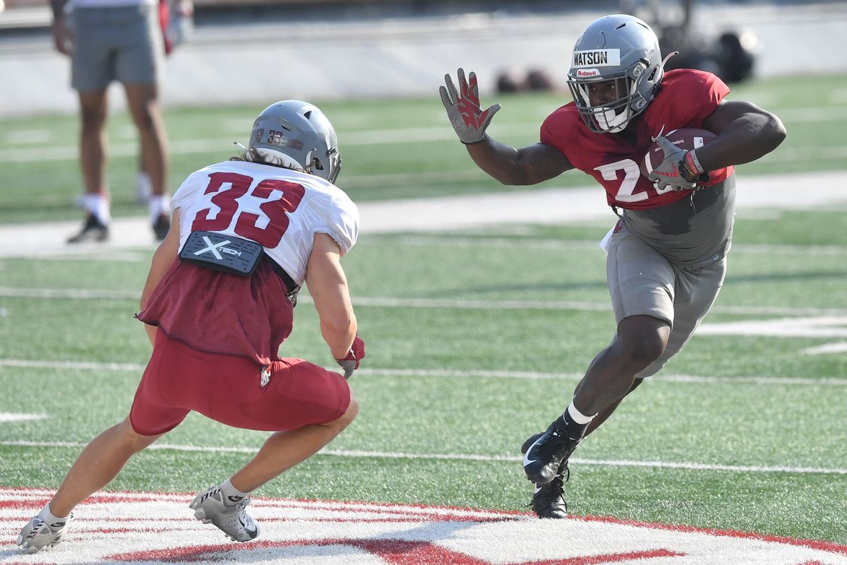 Washington State Cougars running back Nakia Watson (25) runs the ball against Washington State Cougars defensive back Henry Kimmins (33) during a scrimmage on Saturday, Aug. 20, 2022, at Martin Stadium in Pullman, Wash.  (Tyler Tjomsland/The Spokesman-Review)