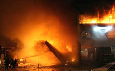 
Firefighters try to extinguish a fire at the site where a TAM airlines commercial jet crashed in Sao Paulo on Tuesday. Associated Press
 (Associated Press / The Spokesman-Review)