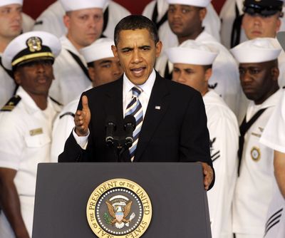 With naval officers behind him, President Barack Obama speaks at  Naval Air Station Jacksonville on Monday. (The Spokesman-Review)