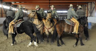 Members of the U.S. Border Patrol put their mustangs through their paces in December at the Mountain House Stables near Colville.  (Dan Pelle / The Spokesman-Review)