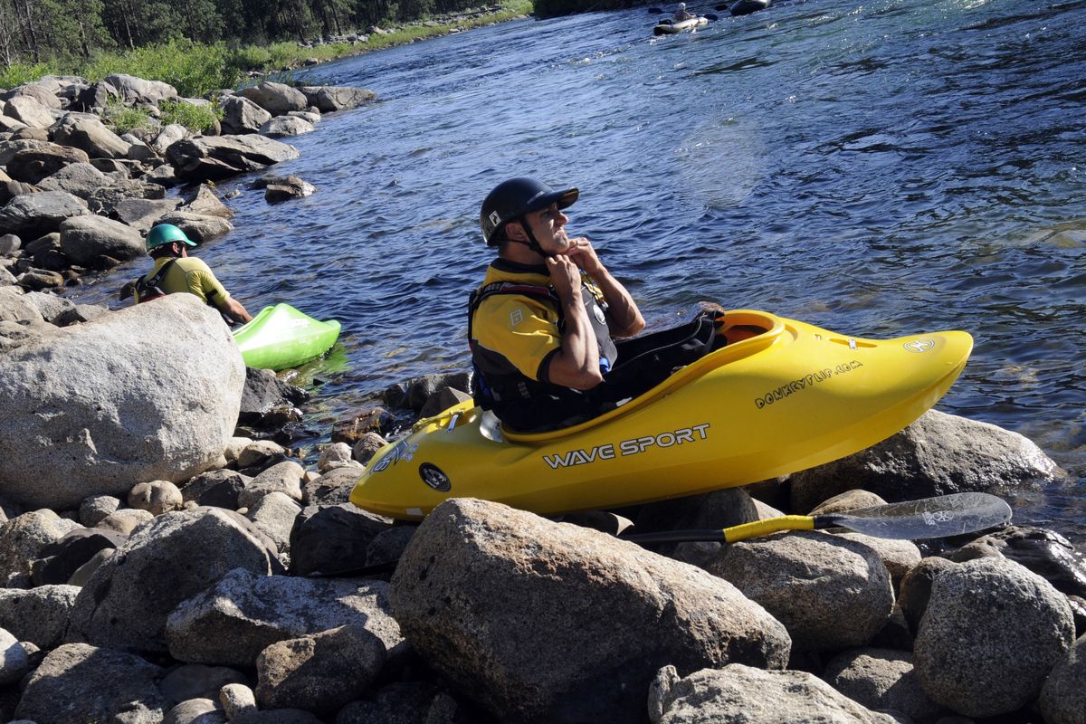Spokane Valley kayaker Steve Bailey adjusts his helmet before launching with kayaker Mike Hamm on the upper Spokane River, Mon. evening, August 1, 2011. The pair were headed to "Sullivan Hole", a wave that is a Spokane River low water play spot for whitewater enthusiasts. J. (J. Rayniak / The Spokesman Review)