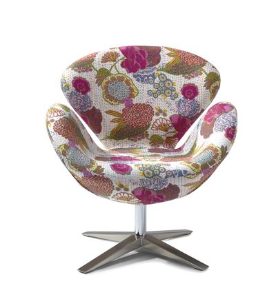 This contemporary bucket chair with a vibrant floral print from HomeGoods brings upbeat summer style to a variety of spaces. (Associated Press)