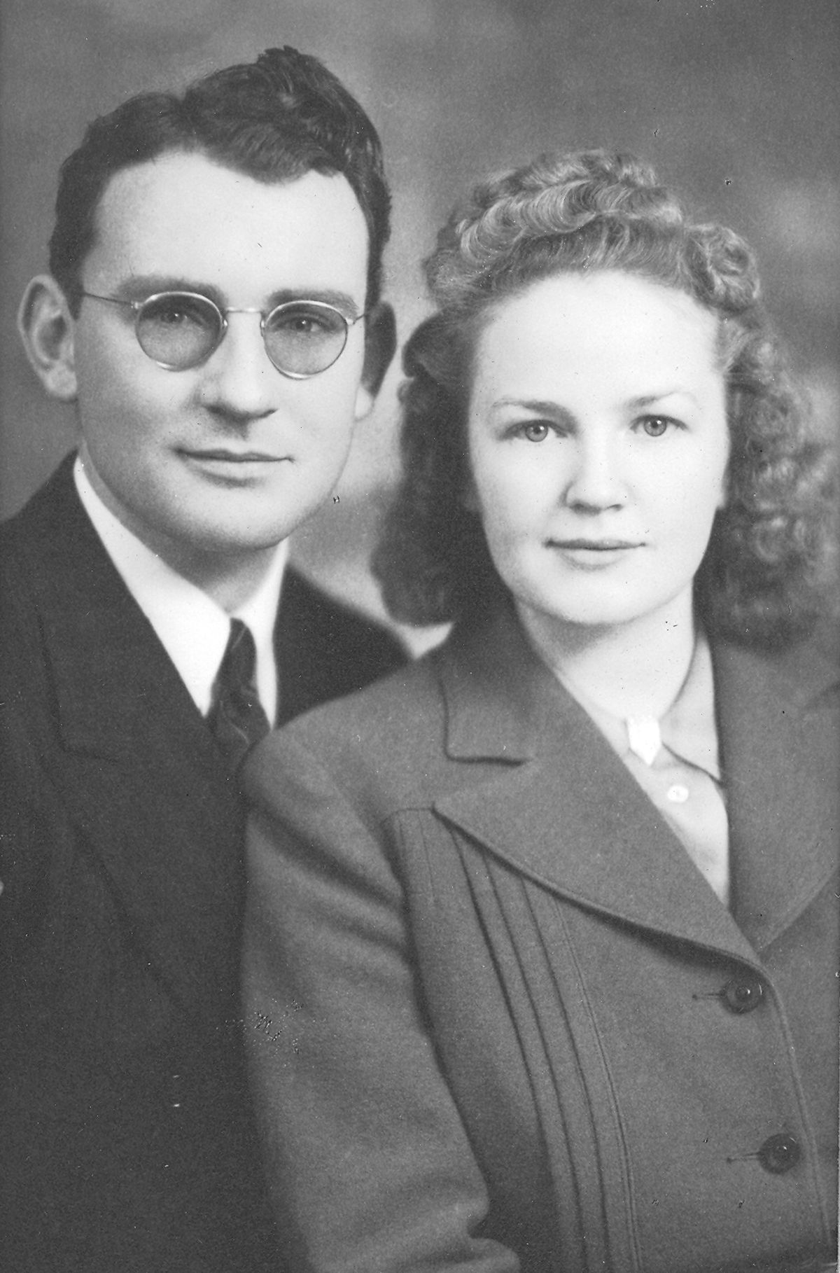 The unidentified couple at left could be posing for a wedding photo. It looks World War II-like, the hairstyle and the clothing. And in the war years, brides often married in sedate suits. But the man wears no uniform, so perhaps it was taken just before the war.