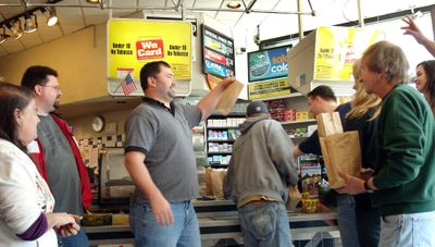 Employees of MMI collect their lunches Friday at neighboring Broadway Station convenience store at the corner of Broadway Avenue and Fancher Road.  (John  Craig / The Spokesman-Review)