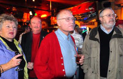 
Coeur d'Alene City Council candidate John Bruning, center right,  and City Councilman Ron Edinger, center left,  listen  as the latest election returns are read Tuesday night at Cricket's Restaurant in Coeur d'Alene. They're joined by  supporters Nicki Anderson, left, and Garry Loeffler. 
 (Jesse Tinsley / The Spokesman-Review)