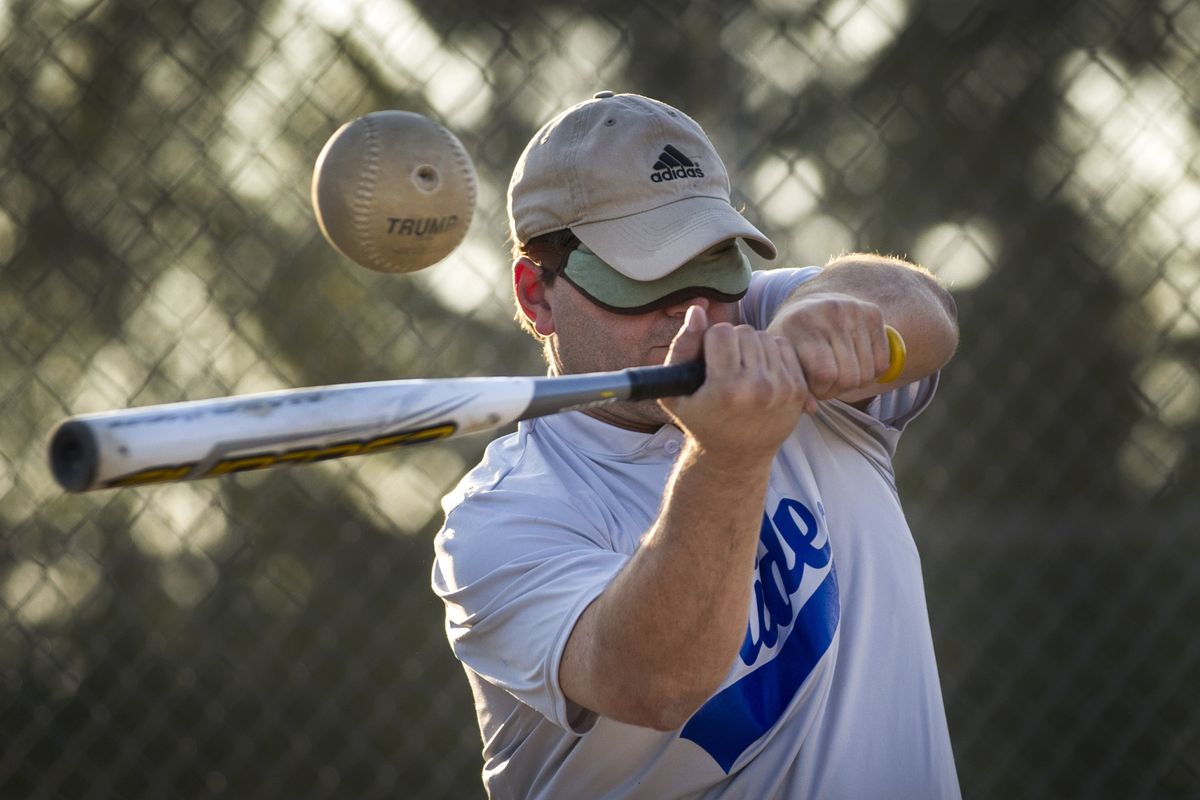 At a Spokane Pride beep baseball scrimmage, team captain and coach Troy Leeberg takes a swing at a softball that emits beeping sounds on Thursday at Franklin Park. Beep baseball is adapted for the blind and visually impaired. (Colin Mulvany)