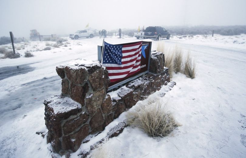An American flag hangs on the sign at the front entrance of the Malheur National Wildlife Refuge Thursday, Jan. 7, 2016, near Burns, Ore. (Rick Bowmer / Associated Press)