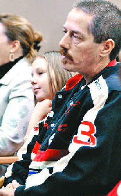 
Katelynn Groves, 10, and her father, Craig Groves, both of Olympia, watch a Senate hearing Tuesday. Lawmakers are considering setting up a 