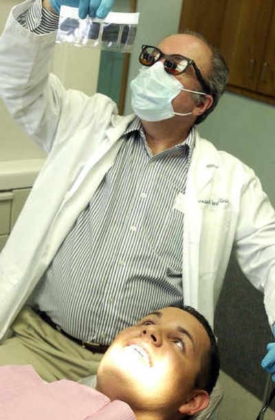 
Nathan SiJohn talks with dentist Frank Allen about his teeth after a checkup at the Benewah Medical Center in Plummer on Tuesday. 
 (Jesse Tinsley / The Spokesman-Review)