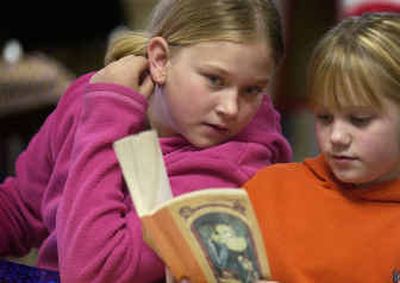 
Jade Shell, 10, left, and Ashley Rucker, 10, read 