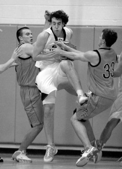 
Lake City's Nick Fromm secures a rebound in the second quarter as Post Falls' Dan Anderson goes for the ball Friday night at Lake City. 
 (Bruce Twitchell Special to / The Spokesman-Review)