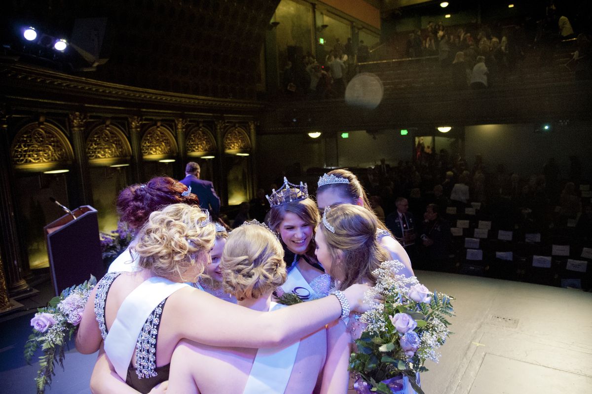 Meghan Long, center right, with large tiara, of Ferris High School gathers her court of six princesses for a celebratory huddle onstage after she was selected as the 2015 Lilac Festival Queen Sunday at the Bing Crosby Theater in Spokane. (Jesse Tinsley)