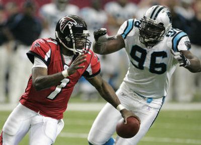 
Panthers defender Al Wallace runs down Falcons quarterback Michael Vick during second-half action in Atlanta.
 (Associated Press / The Spokesman-Review)