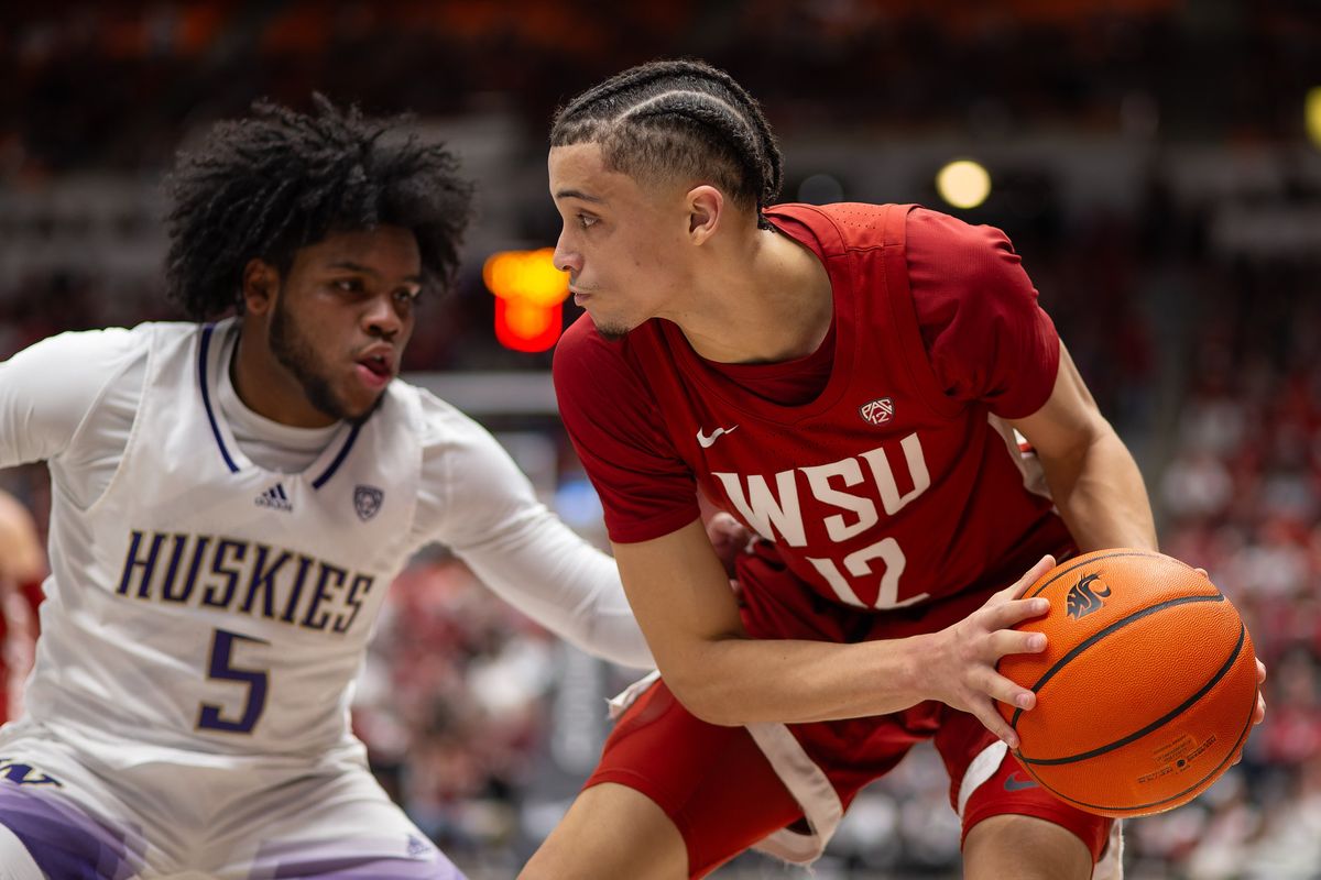 Washington State guard Isaiah Watts looks for a way around Washington guard Sahvir Wheeler during the first half on March 7 at Beasley Coliseum in Pullman.  (Geoff Crimmins/The Spokesman-Review)