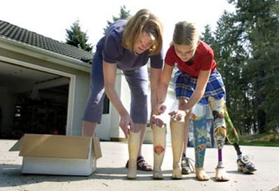 
Hannnah Cvancara, 10, and her mother Anne sort Hannah's old prosthetics by size in front of their north Spokane home. Hannah was born without a femur and has worn a prosthetic from the time she could walk.
 (Joe Barrentine The Spokesman Review / The Spokesman-Review)
