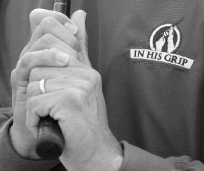 Scott Lehman displays the logo of In His Grip Golf Association, an organization he founded to teach churches how to use golf as a way to share Christianity. 
 (Associated Press Photos / The Spokesman-Review)